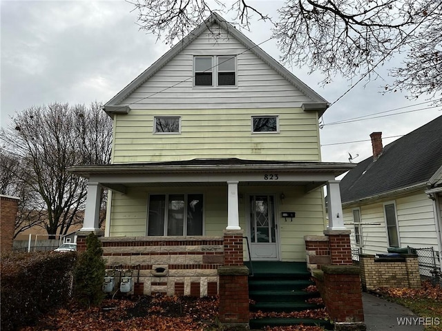 american foursquare style home with a porch