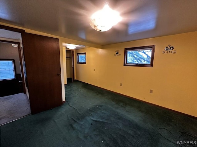 empty room with baseboards and carpet flooring