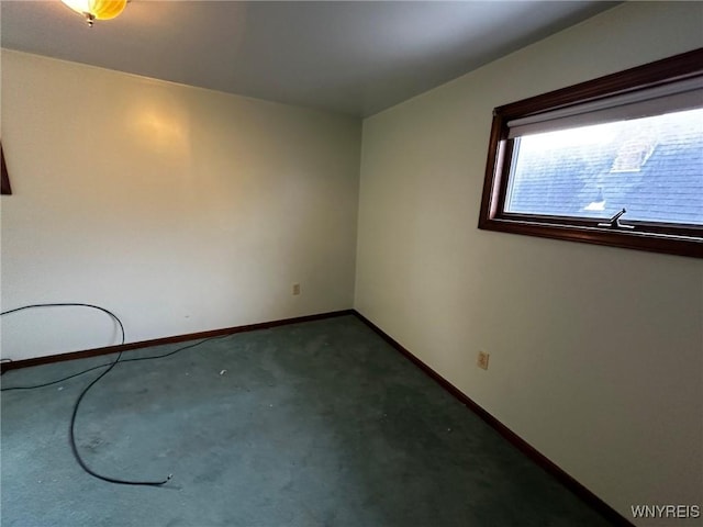 spare room with carpet and baseboards