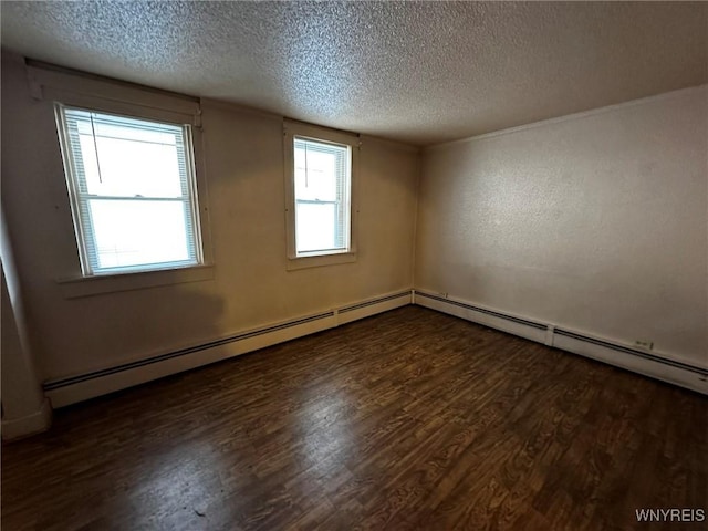 empty room featuring a textured ceiling and wood finished floors