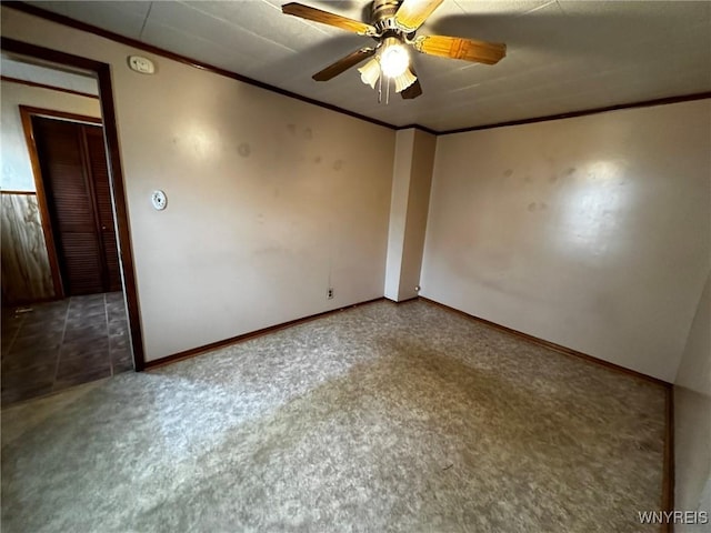 unfurnished room featuring baseboards, ornamental molding, and a ceiling fan