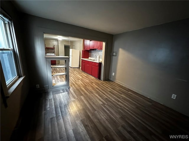 interior space with baseboards, dark wood finished floors, and a sink