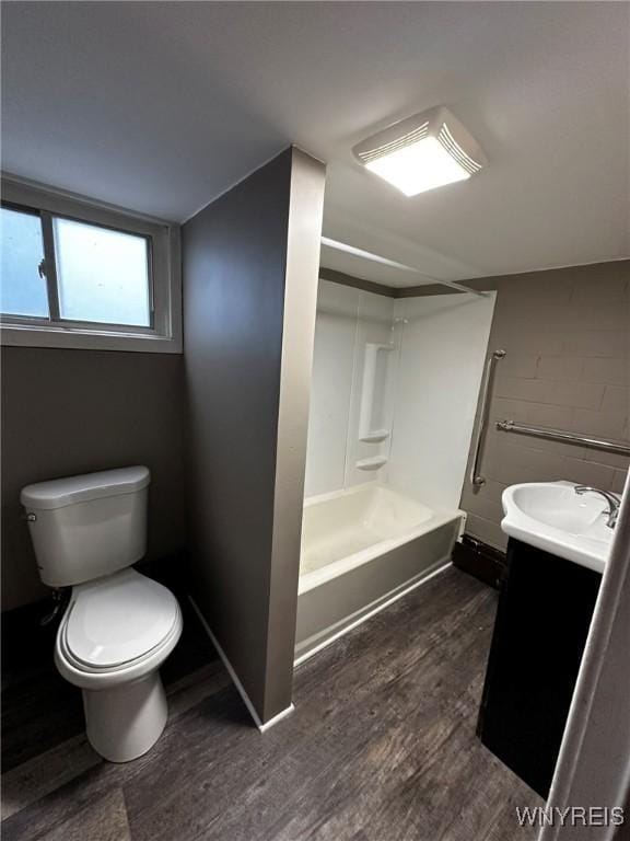 bathroom featuring vanity, shower / bath combination, wood finished floors, and toilet