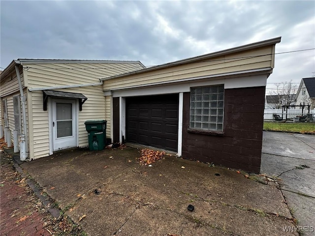 exterior space with driveway and fence