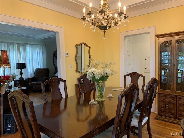 dining space featuring ornamental molding and wood finished floors