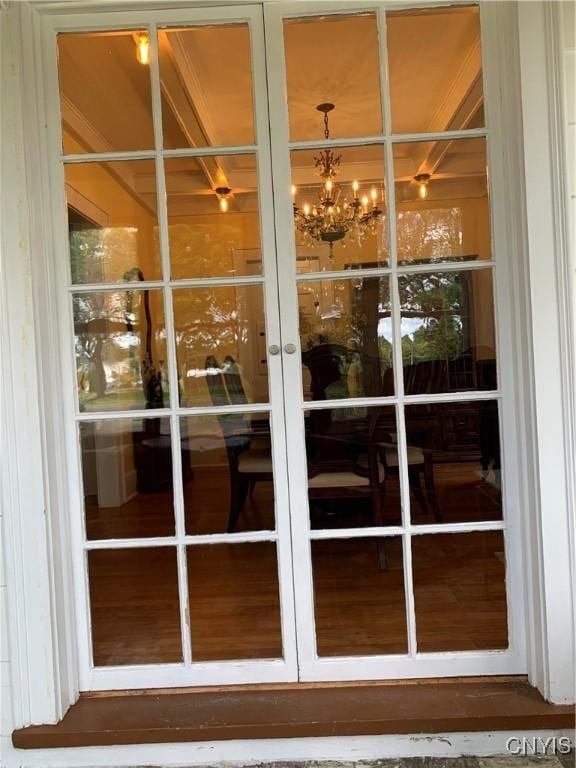 entryway featuring french doors and an inviting chandelier