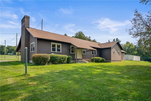 single story home with a front lawn, a chimney, a shingled roof, and fence