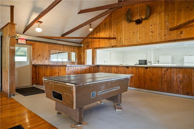 recreation room featuring concrete flooring, vaulted ceiling with beams, and wood walls