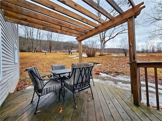 wooden deck featuring outdoor dining area and a pergola