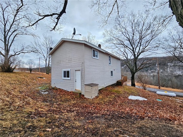 view of property exterior with a chimney