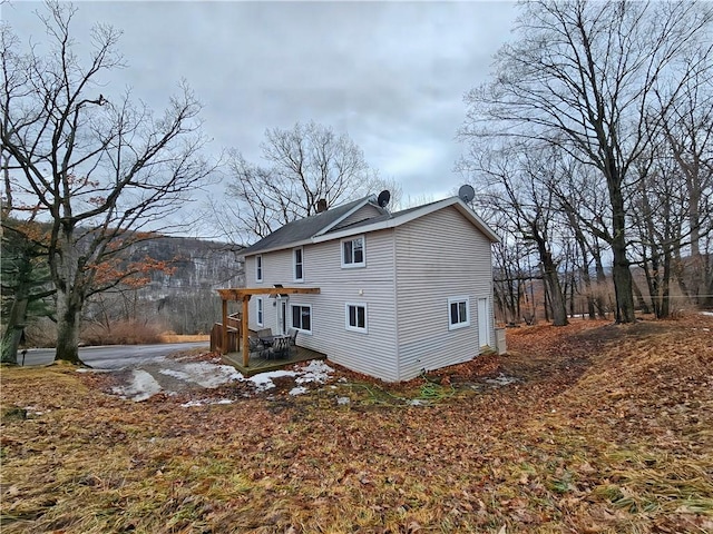 rear view of house featuring a chimney