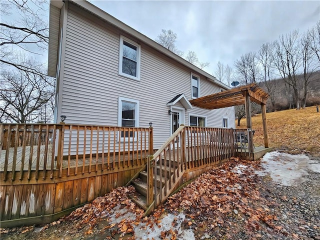 back of property featuring a wooden deck