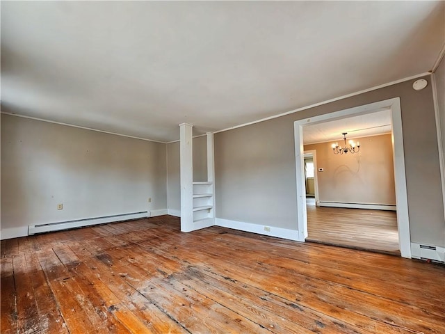 unfurnished room featuring a baseboard heating unit, wood-type flooring, and crown molding