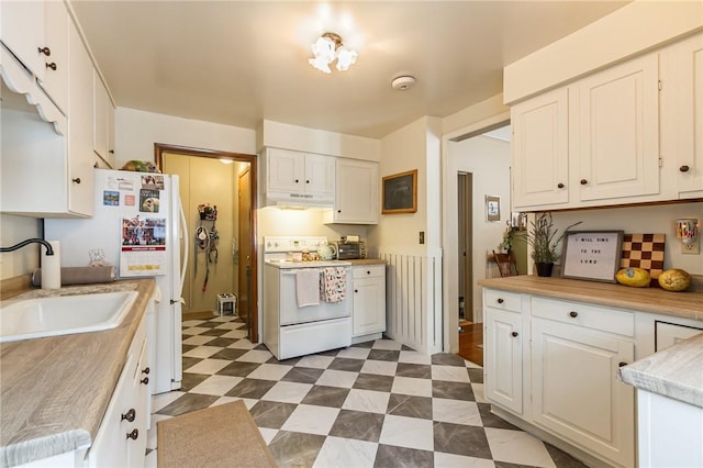 kitchen featuring dark floors, light countertops, a sink, white appliances, and under cabinet range hood