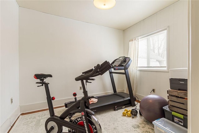 workout room featuring baseboards