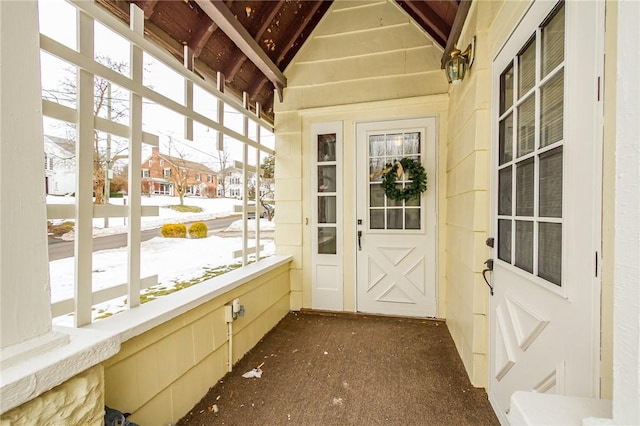 unfurnished sunroom featuring a residential view and vaulted ceiling