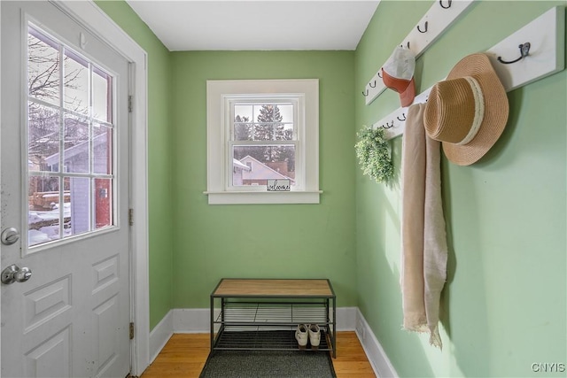 doorway with light wood-style flooring and baseboards