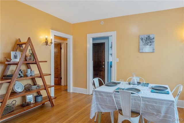 dining room featuring baseboards and light wood-style floors