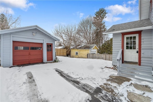 exterior space featuring a garage and fence