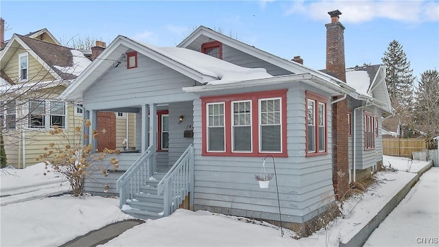 bungalow with fence and a chimney