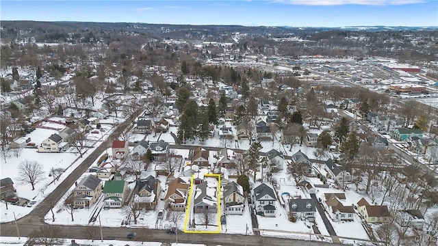 snowy aerial view with a residential view