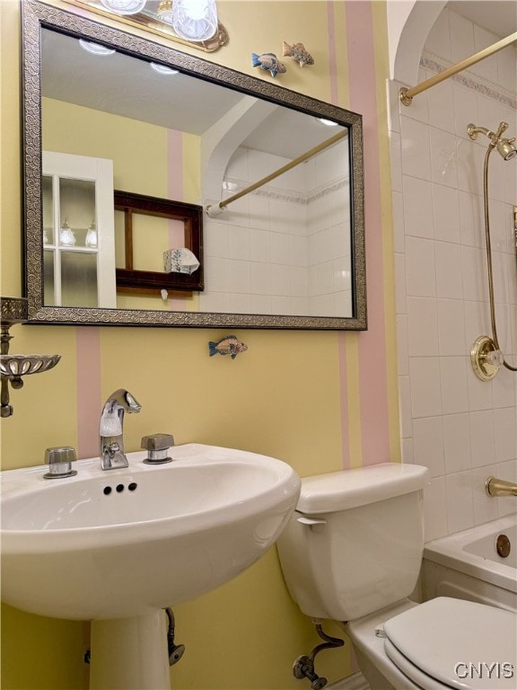 full bath featuring tub / shower combination, a sink, and toilet