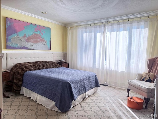 bedroom featuring a textured ceiling and ornamental molding