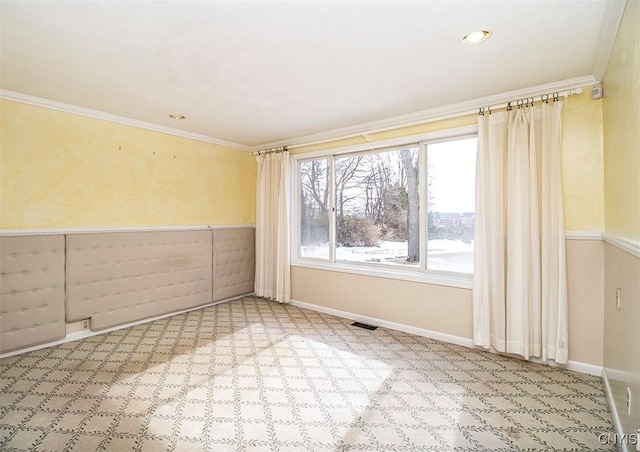 unfurnished room with ornamental molding, visible vents, carpet floors, and baseboards