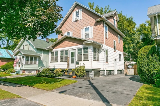 view of front of house with entry steps and a front lawn