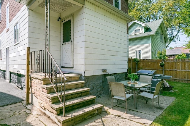 view of patio with outdoor dining area and fence