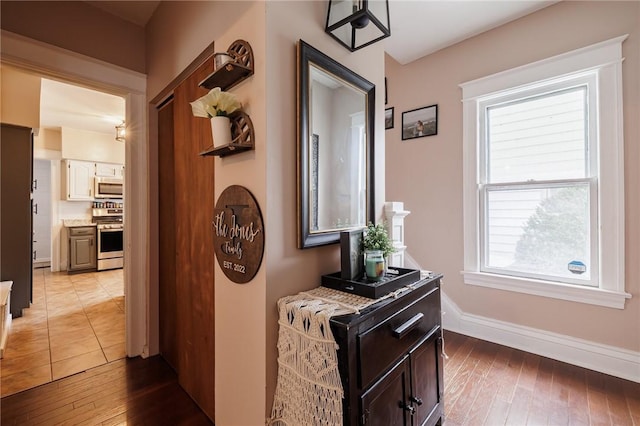 hallway with light wood-style floors and baseboards