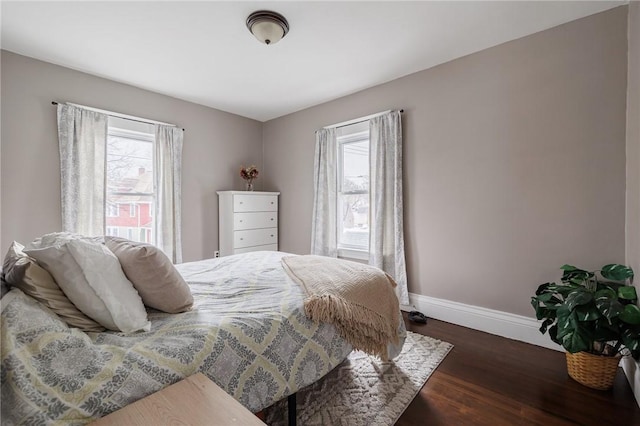 bedroom featuring dark wood-type flooring and baseboards