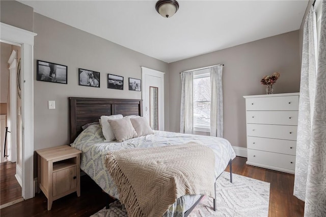 bedroom featuring baseboards and wood finished floors