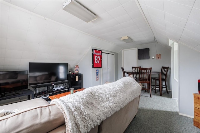 carpeted bedroom featuring lofted ceiling and baseboards