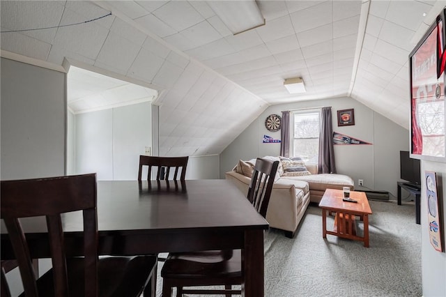 dining room with lofted ceiling and carpet floors