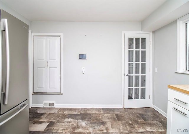 washroom with stone finish floor, visible vents, and baseboards