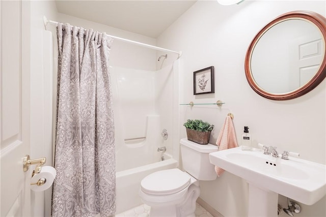 bathroom with shower / tub combo, a sink, and toilet