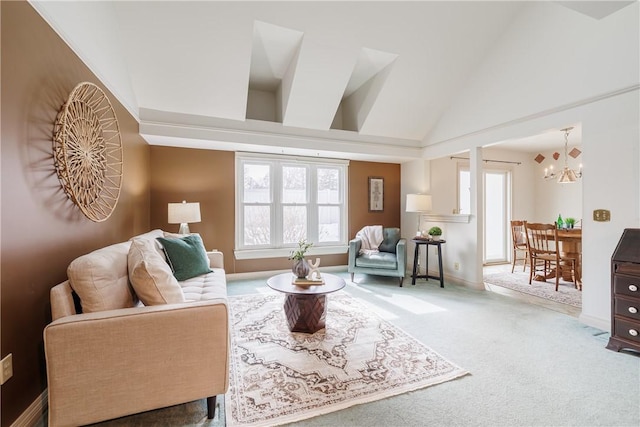 living area featuring carpet floors, baseboards, vaulted ceiling, and a notable chandelier