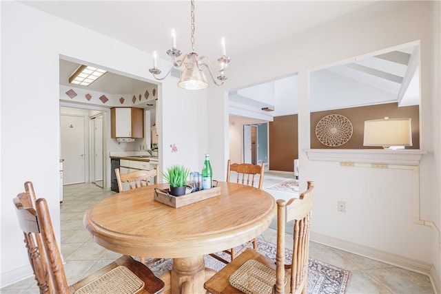 dining space featuring a chandelier, light tile patterned flooring, and baseboards