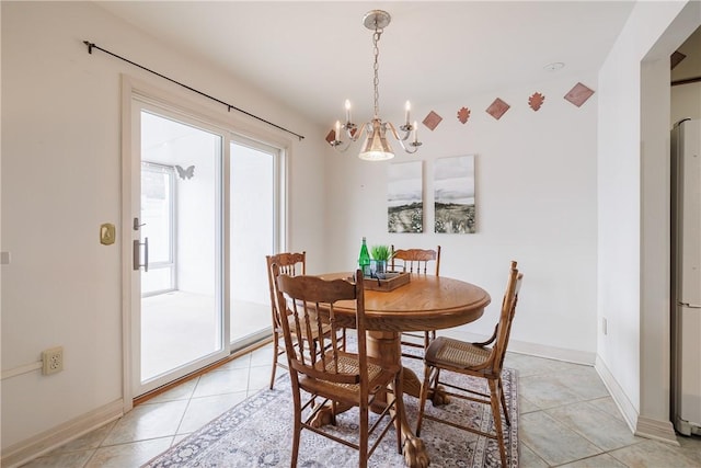 dining room with light tile patterned floors, an inviting chandelier, and baseboards