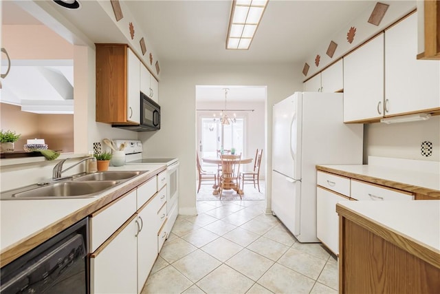 kitchen featuring light countertops, a sink, black appliances, and white cabinetry