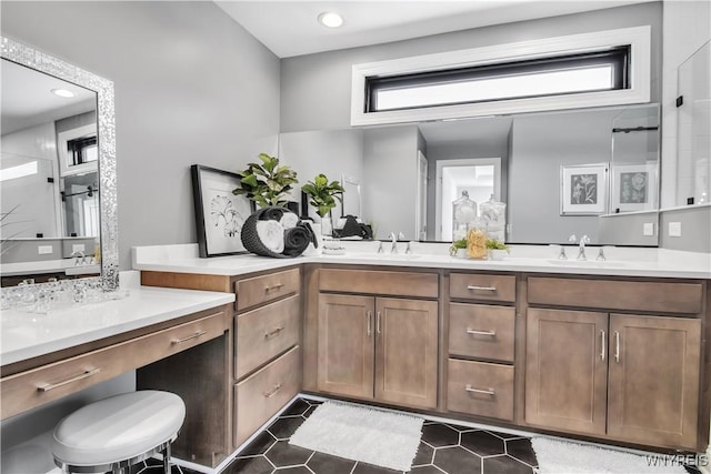 bathroom featuring double vanity, a sink, and tile patterned floors