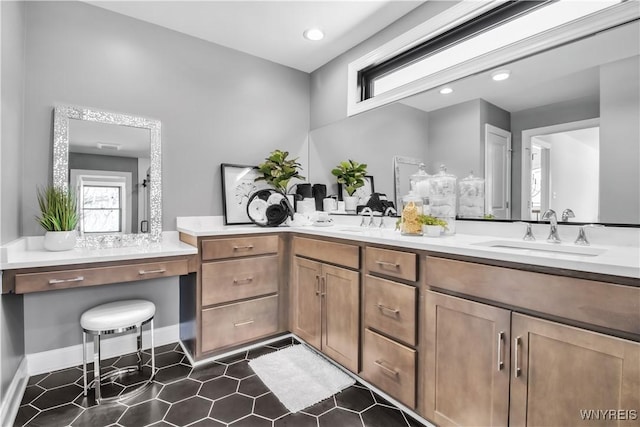 full bathroom featuring double vanity, a sink, baseboards, and tile patterned floors