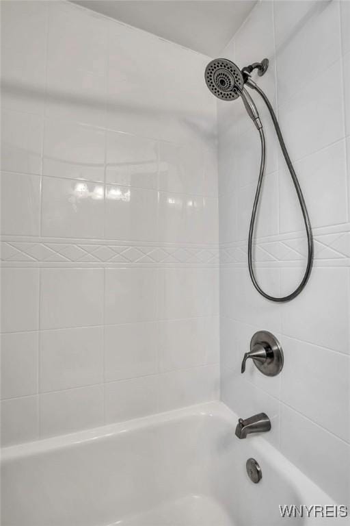 room details featuring shower / bathtub combination