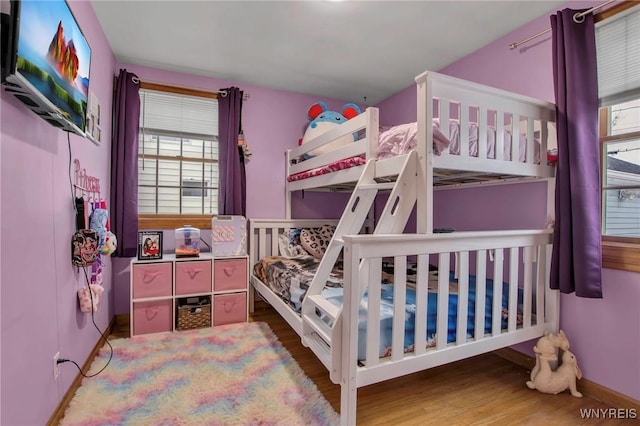 bedroom featuring baseboards and wood finished floors