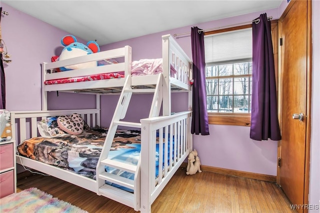 bedroom featuring baseboards and wood finished floors