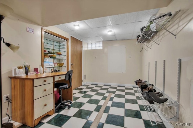 office featuring a paneled ceiling and tile patterned floors