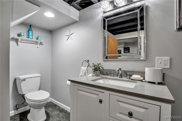 half bath featuring toilet, tile patterned flooring, baseboards, and vanity