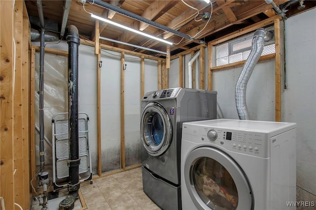 laundry room with laundry area and washing machine and clothes dryer