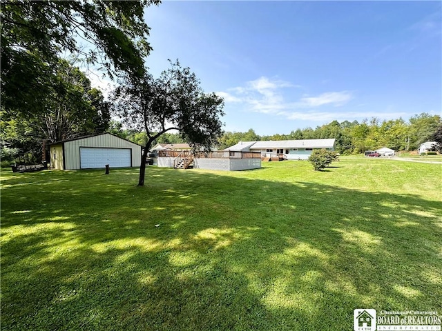 view of yard with an outbuilding and a detached garage